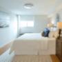 Brightly lit bedroom with custom roll-up blinds. Brightly lit bedroom with custom roll-up blinds.