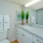 Bathroom with large stone countertop and modern cabinetry. Bathroom with large stone countertop and modern cabinetry.