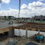Finishers working on the finishing of the concrete slab for Northern Properties with the concrete pump placing concrete in the background. Finishers working on the finishing of the concrete slab for Northern Properties with the concrete pump placing concrete in the background.