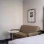 Newly renovated guest room with couch and table Newly renovated guest room with couch and table
