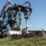 Bobcat S590 skid-steer loader uses planetary auger attachment to dig fence posts. Bobcat S590 skid-steer loader uses planetary auger attachment to dig fence posts.