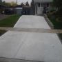 Concrete driveway with spin float finish and control joint saw cuts. Concrete driveway with spin float finish and control joint saw cuts.
