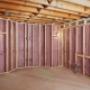 Insulthane Extreme insulation in an attic. He spreads it on walls and floor, ensuring thorough coverage for optimal insulation. Insulthane Extreme insulation in an attic. He spreads it on walls and floor, ensuring thorough coverage for optimal insulation.