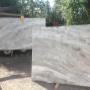 Bookmatched Fantasy Brown Quartzite Slabs being off-loaded from delivery transport. Bookmatched Fantasy Brown Quartzite Slabs being off-loaded from delivery transport.
