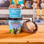 Waffle cone, cup and fresh packed pint in front of Ben & Jerry's ice cream shop menu board. Waffle cone, cup and fresh packed pint in front of Ben & Jerry's ice cream shop menu board.