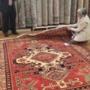 A customer, with a notebook in hand, carefully examines a Caucasian carpet she recently dropped off at our Montreal Store for repairs. The verdict: A+ A customer, with a notebook in hand, carefully examines a Caucasian carpet she recently dropped off at our Montreal Store for repairs. The verdict: A+