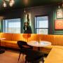 Black roller shades in colorful speakeasy. Black roller shades in colorful speakeasy.