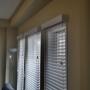 Side View of 2 Inch Routeless Faux Wood Blinds with Stately Valance on Living Room Windows in an Aurora Home Side View of 2 Inch Routeless Faux Wood Blinds with Stately Valance on Living Room Windows in an Aurora Home