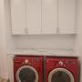 Laundry room In Oxford White, with one-piece shaker style doors and brushed nickel handles. The counter-top is Laminate marble with rounded edges. Laundry room In Oxford White, with one-piece shaker style doors and brushed nickel handles. The counter-top is Laminate marble with rounded edges.
