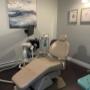 ID for accessibility: our second treatment room. Dimmed lighting, beige dental chair, large blue and gold canvas on the wall to the left and gold framed dental art on the back wall. ID for accessibility: our second treatment room. Dimmed lighting, beige dental chair, large blue and gold canvas on the wall to the left and gold framed dental art on the back wall.