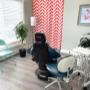 ID for accessibility: Tobi Stuckless' RDH treatment room. Shows a blue dental chair, plants, an orange and white (chevron pattern) curtain in the back of the room and dental delivery system. ID for accessibility: Tobi Stuckless' RDH treatment room. Shows a blue dental chair, plants, an orange and white (chevron pattern) curtain in the back of the room and dental delivery system.