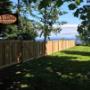 CV Cedar West Coast Style Fence, panel capped with a 2x4. Walk-through Gate with Black Metal Auto Latch. Posts finished with cedar post caps. CV Cedar West Coast Style Fence, panel capped with a 2x4. Walk-through Gate with Black Metal Auto Latch. Posts finished with cedar post caps.