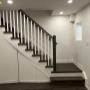 New built staircase with plain white wooden pickets New built staircase with plain white wooden pickets