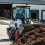 A Bobcat L28 small articulated loader with bucket attachment A Bobcat L28 small articulated loader with bucket attachment
