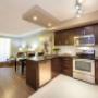Open-concept kitchen with breakfast bar and stainless steel appliances at Juliana Place in Woodstock, ON Open-concept kitchen with breakfast bar and stainless steel appliances at Juliana Place in Woodstock, ON