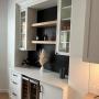 Built-in with glass doors, floating shelves and quartz countertop Built-in with glass doors, floating shelves and quartz countertop