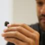 a client holding up a hearing aid a client holding up a hearing aid