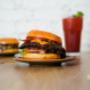 Smash burger with cheddar, bacon, and fresh toppings.
Smash burger avec cheddar, bacon et garnitures fraîches. Smash burger with cheddar, bacon, and fresh toppings.
Smash burger avec cheddar, bacon et garnitures fraîches.