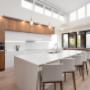 Glossy white and walnut cabinetry work together in this contemporary take on lake living. Glossy white and walnut cabinetry work together in this contemporary take on lake living.