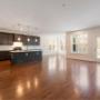 Image of an empty kitchen and dining room. The job was a move-out clean. The floors are dark brown and the kitchen cabinets are black. The oven and stove are stainless steel colour. There is a lot of natural light that comes through the windows. Image of an empty kitchen and dining room. The job was a move-out clean. The floors are dark brown and the kitchen cabinets are black. The oven and stove are stainless steel colour. There is a lot of natural light that comes through the windows.