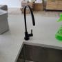 Complete water filtration system installation with addition of filtered water tap installed through quartz countertop. Complete water filtration system installation with addition of filtered water tap installed through quartz countertop.