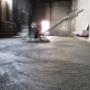 Helicopter concrete floor finishing on construction site. Construction worker finishing concrete screed with power trowel machine Helicopter concrete floor finishing on construction site. Construction worker finishing concrete screed with power trowel machine