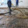 Worker pouring cement Worker pouring cement