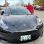 A satisfied Roam Monthly Car Subscriptions & Rentals customer standing beside his new Tesla A satisfied Roam Monthly Car Subscriptions & Rentals customer standing beside his new Tesla