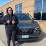 A happy Roam Monthly Car Subscriptions & Rentals customer in front of her new Hyundai A happy Roam Monthly Car Subscriptions & Rentals customer in front of her new Hyundai
