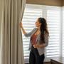 Neutral shutters & drapery in a bedroom. Neutral shutters & drapery in a bedroom.