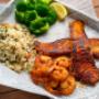 ZESTY CAJUN COMBO - Pan seared Cod and juicy sautéed shrimp with Cajun spices. Served with two sides. ZESTY CAJUN COMBO - Pan seared Cod and juicy sautéed shrimp with Cajun spices. Served with two sides.
