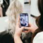 Friendly, professional hair stylists and nail technicians pose together in the modern, chic salon Friendly, professional hair stylists and nail technicians pose together in the modern, chic salon