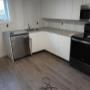 Countertop has been installed and the appliances are in place. Egress window has been trimmed. The bare drywall is all getting tiled. Countertop has been installed and the appliances are in place. Egress window has been trimmed. The bare drywall is all getting tiled.