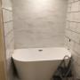 Wall tiles and tub are in. Wall tiles and tub are in.