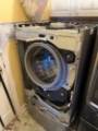 Front-load washing machine repair in progress full disassembly for diagnostics and part replacement Front-load washing machine repair in progress full disassembly for diagnostics and part replacement