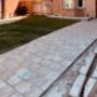 Modern interlock driveway installation with clean geometric pattern and dark border accents. Custom stone pavers enhance curb appeal for this residential home. Modern interlock driveway installation with clean geometric pattern and dark border accents. Custom stone pavers enhance curb appeal for this residential home.