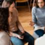 A group therapy session in progress, with participants engaged in open conversation—fostering connection, support, and shared healing in a safe environment. A group therapy session in progress, with participants engaged in open conversation—fostering connection, support, and shared healing in a safe environment.